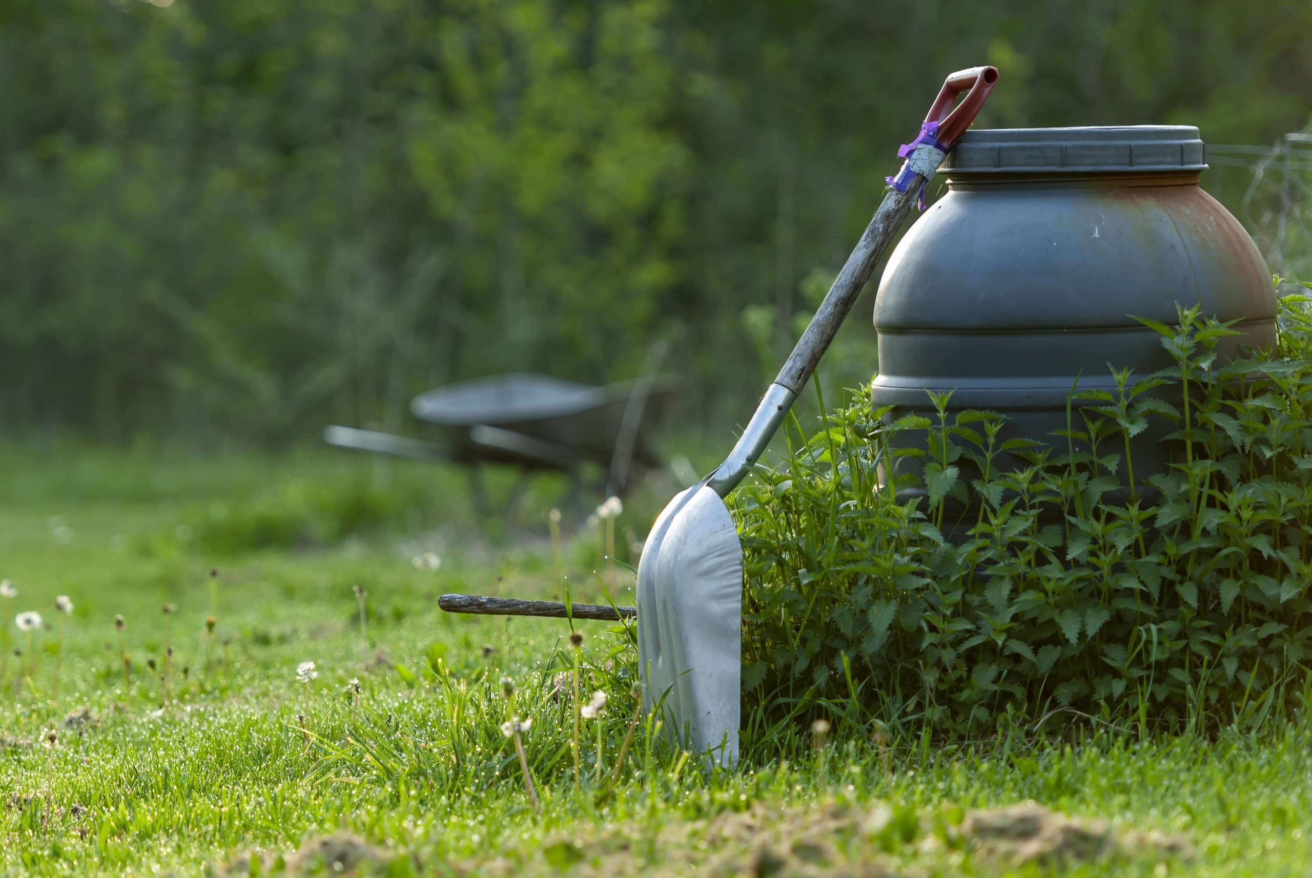 closeup-shot-shovel-garden-with-trees